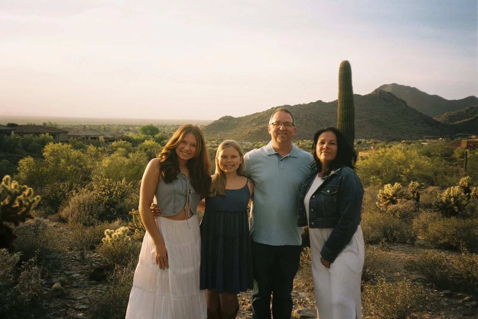 Family in the desert among saguaro cactus, shot on 35mm film