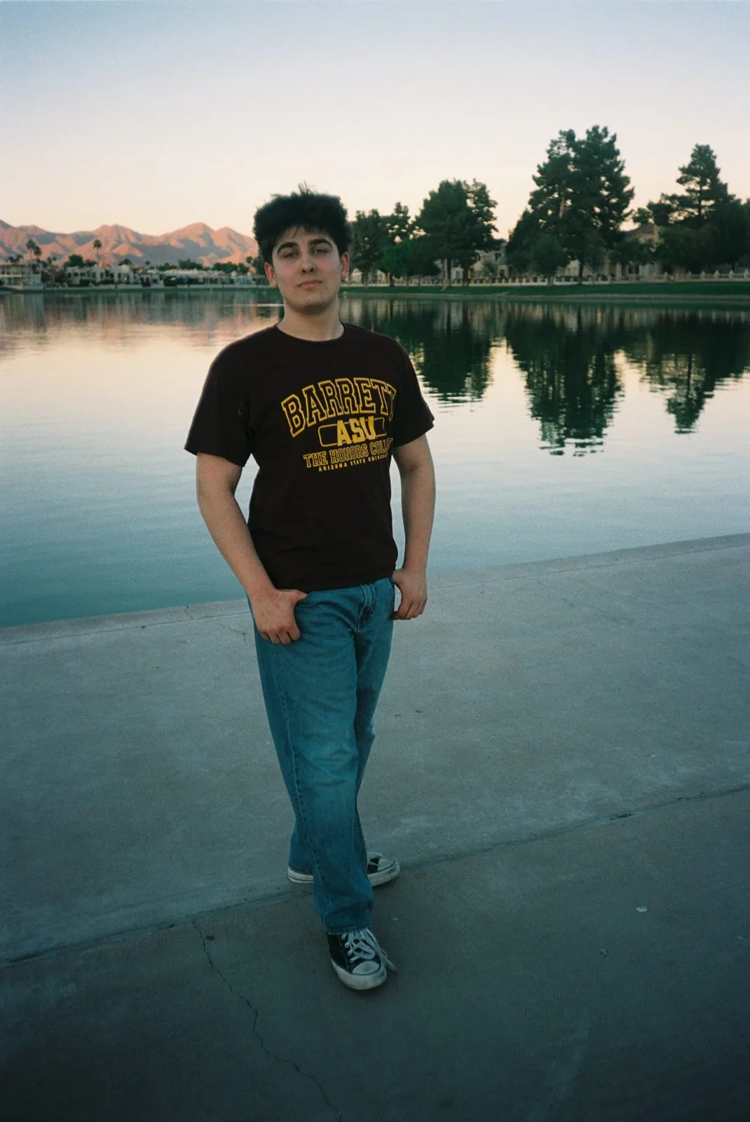 Senior portrait by the lake at dusk, shot on 35mm film