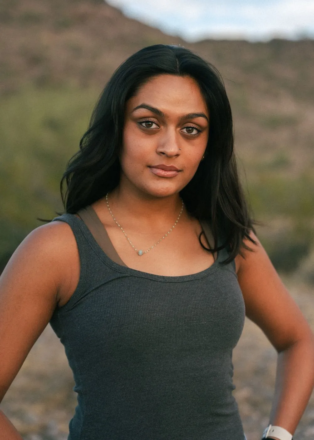Senior portrait of a young woman in the desert at dusk