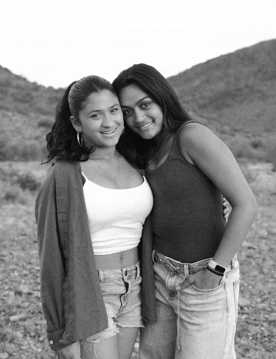 Black and white portrait of two sisters cheek to cheek
