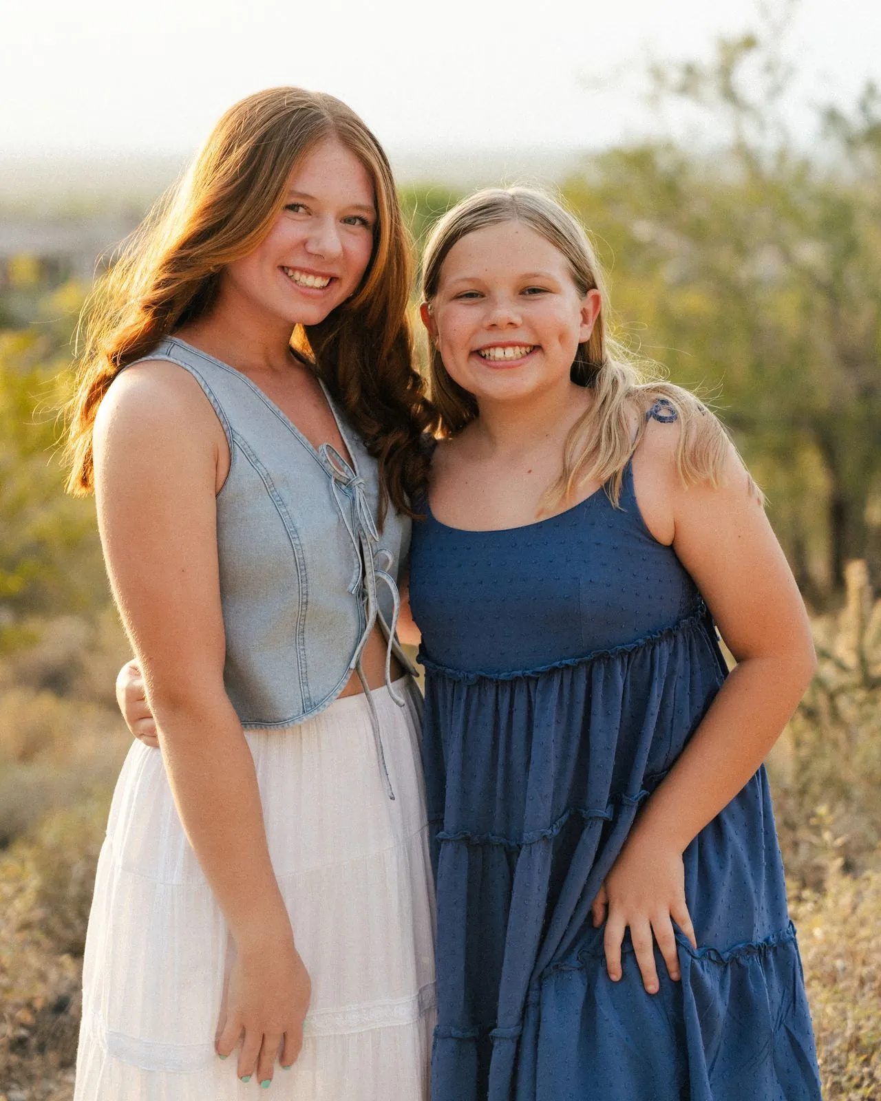 Two sisters hugging and smiling