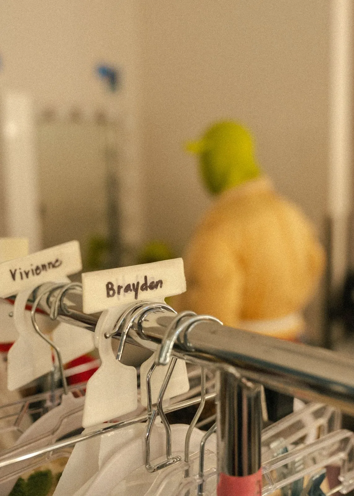 Costume rail with hand-written name tags backstage