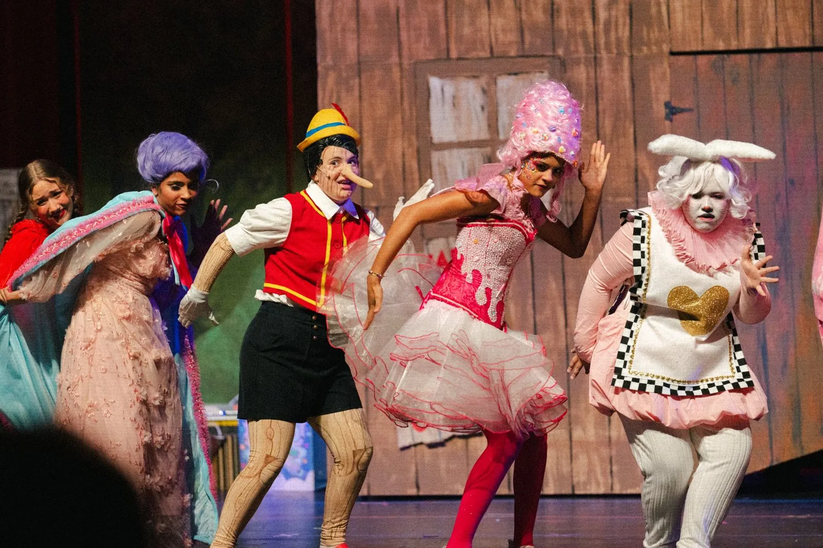 Fairytale characters dancing in a line on stage